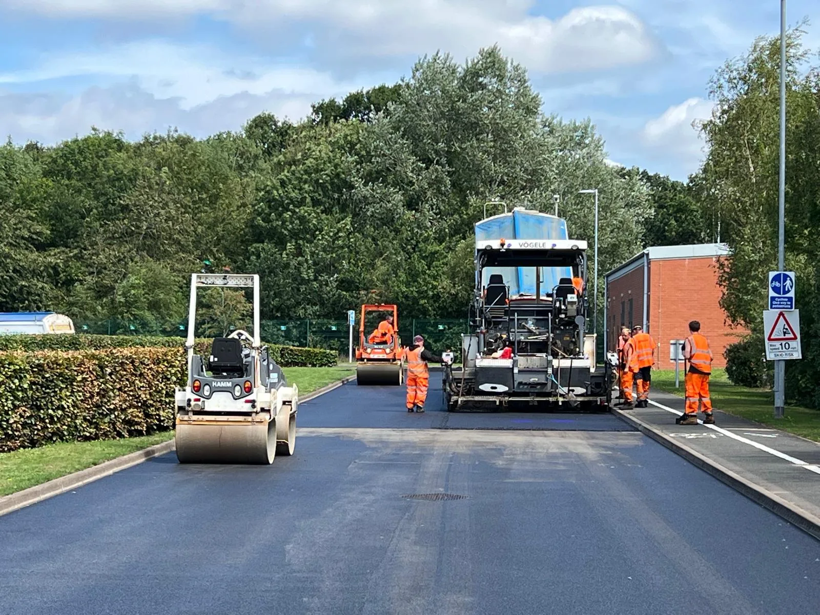 Stardom Ltd road surfacing crew with Vögele paver and Hamm roller